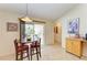 Cozy kitchen nook featuring a round table with chairs, a sliding glass door, and tile flooring at 1857 N San Mateo Dr, North Port, FL 34288