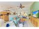 Comfortable living room featuring an open layout, ceiling fan, and neutral color palette at 1857 N San Mateo Dr, North Port, FL 34288