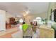 Spacious living area with a dining space, wooden floors, and arched windows, perfect for relaxation at 1857 N San Mateo Dr, North Port, FL 34288