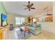 A comfortable living room featuring neutral tile, a ceiling fan and casual furniture at 1857 N San Mateo Dr, North Port, FL 34288
