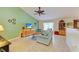 Cozy living room with a comfortable couch, tiled flooring, and bright green accent wall at 1857 N San Mateo Dr, North Port, FL 34288