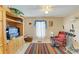 Bright living space with large window, vibrant rug, and wood entertainment center at 1857 N San Mateo Dr, North Port, FL 34288