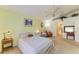 Spacious bedroom features a ceiling fan, an arched doorway, and a cozy seating area at 1857 N San Mateo Dr, North Port, FL 34288