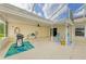 Spacious covered patio with ample seating and a grill, perfect for entertaining guests at 1857 N San Mateo Dr, North Port, FL 34288