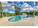 Private screened-in pool area with comfortable lounge chairs, offering a serene retreat at 1857 N San Mateo Dr, North Port, FL 34288