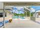 Screened-in pool area with a spa and ample lounge seating, perfect for relaxation at 1857 N San Mateo Dr, North Port, FL 34288