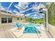 Inviting screened-in pool and spa area with lounge chairs, ideal for outdoor enjoyment at 1857 N San Mateo Dr, North Port, FL 34288