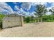 Backyard shed near a gravel driveway and charming pergola, providing ample storage space at 1857 N San Mateo Dr, North Port, FL 34288