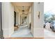 Inviting walkway lined with elegant columns, stylish lighting fixtures, and comfortable seating areas at 1857 N San Mateo Dr, North Port, FL 34288