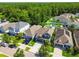 Aerial view of several suburban homes with well-manicured lawns, lush landscaping, and mature trees at 11307 Quiet Forest Dr, Tampa, FL 33635