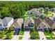 Aerial view of suburban homes showcasing well-manicured lawns, pools, and mature trees at 11307 Quiet Forest Dr, Tampa, FL 33635