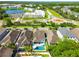 Aerial view of neighborhood showcasing a roundabout, landscaping, nearby amenities, and community layout at 11307 Quiet Forest Dr, Tampa, FL 33635