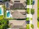 Overhead view of several homes, showcasing driveways and pools, emphasizing property lines and neighborhood layout at 11307 Quiet Forest Dr, Tampa, FL 33635