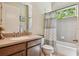 Cozy bathroom featuring a vanity with a sink, toilet, and a tiled shower-tub combo at 11307 Quiet Forest Dr, Tampa, FL 33635
