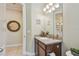 The bathroom features a vanity with a sink, light fixtures, and a decorative mirror at 11307 Quiet Forest Dr, Tampa, FL 33635