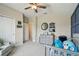 Bright Bedroom with blue accents, gray furniture, and views to the hall and closet at 11307 Quiet Forest Dr, Tampa, FL 33635