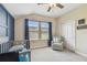 Bedroom featuring natural light, blue accent wall, comfortable gray chair and ample closet space at 11307 Quiet Forest Dr, Tampa, FL 33635