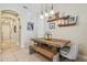 Dining space with a wooden table, bench seating, stylish decor, and modern pendant lighting at 11307 Quiet Forest Dr, Tampa, FL 33635