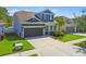 Charming two-story home with a spacious driveway, two-car garage, and well-kept lawn at 11307 Quiet Forest Dr, Tampa, FL 33635