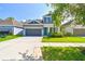 Beautiful two-story home with a two-car garage, manicured lawn, and bright entryway at 11307 Quiet Forest Dr, Tampa, FL 33635