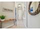 Inviting hallway with a decorative mirror, console table, and 'Home Sweet Home' wall decor at 11307 Quiet Forest Dr, Tampa, FL 33635
