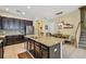 Open kitchen with stainless steel appliances, granite counters, and a center island adjacent to the dining area at 11307 Quiet Forest Dr, Tampa, FL 33635