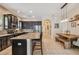 A modern kitchen features stainless steel appliances, dark wood cabinetry, and a granite countertop island at 11307 Quiet Forest Dr, Tampa, FL 33635