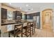 An open-concept kitchen boasts stainless steel appliances, granite countertops, and dark wood cabinets at 11307 Quiet Forest Dr, Tampa, FL 33635