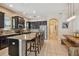 A stylish kitchen features a large island, stainless steel appliances, granite countertops, and modern lighting at 11307 Quiet Forest Dr, Tampa, FL 33635
