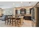 Spacious kitchen with dark cabinets, stainless steel appliances, and a center island with bar seating at 11307 Quiet Forest Dr, Tampa, FL 33635