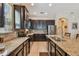 A well-equipped kitchen has dark cabinetry, stainless steel appliances, and a large center island at 11307 Quiet Forest Dr, Tampa, FL 33635