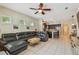 Open-concept living room with tile flooring, ceiling fan, and seamless transition to the kitchen area at 11307 Quiet Forest Dr, Tampa, FL 33635