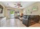 Inviting living room with stone accent wall, tiled floors, and sliding door access to the outdoor pool area at 11307 Quiet Forest Dr, Tampa, FL 33635