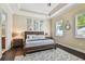 Main bedroom featuring a tray ceiling, wood floors, and ensuite bathroom at 11307 Quiet Forest Dr, Tampa, FL 33635