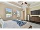 This bedroom boasts wood floors, a tray ceiling, and natural light streaming through the windows at 11307 Quiet Forest Dr, Tampa, FL 33635