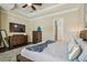Main bedroom featuring wood floors, trey ceiling, and a view of the ensuite bathroom at 11307 Quiet Forest Dr, Tampa, FL 33635