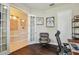 A well-lit office featuring hardwood floors and french doors leading to a cozy sitting room at 11307 Quiet Forest Dr, Tampa, FL 33635