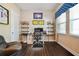 A comfortable office space with hardwood floors, built-in shelves, and natural light from the window at 11307 Quiet Forest Dr, Tampa, FL 33635