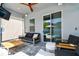 Covered patio featuring a comfortable seating area, ceiling fan, and sliding glass doors to the pool at 11307 Quiet Forest Dr, Tampa, FL 33635