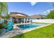 Charming backyard featuring a refreshing pool, comfortable lounge seating, and a manicured lawn, ideal for relaxation and outdoor enjoyment at 11307 Quiet Forest Dr, Tampa, FL 33635