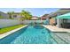Backyard pool view with inviting blue water, lounge seating, and a well-kept lawn for a relaxing outdoor experience at 11307 Quiet Forest Dr, Tampa, FL 33635