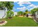 Spacious backyard with lush green lawn, mature trees, and a privacy fence, ideal for outdoor activities and relaxation at 11423 Brighton Knoll Loop, Riverview, FL 33579