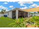 Beautiful backyard with a screened-in lanai, manicured lawn, and lush landscaping at 11423 Brighton Knoll Loop, Riverview, FL 33579