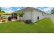 Well-maintained backyard with lush green grass, screened in lanai and mature landscaping at 11423 Brighton Knoll Loop, Riverview, FL 33579