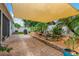 Relaxing backyard with patio, shade sail, pond, and landscaping at 11423 Brighton Knoll Loop, Riverview, FL 33579