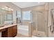 Elegant bathroom featuring a glass-enclosed shower, soaking tub, and vanity with granite countertops, offering a spa-like experience at 11423 Brighton Knoll Loop, Riverview, FL 33579