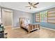 Serene bedroom with wood-like floors, ample natural light, and a comfortable bed, creating a relaxing retreat at 11423 Brighton Knoll Loop, Riverview, FL 33579