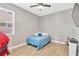 Bedroom with hardwood floors, a large window, and ample natural light at 11423 Brighton Knoll Loop, Riverview, FL 33579
