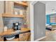 Chic coffee bar area with rustic wooden shelving and modern coffee maker at 11423 Brighton Knoll Loop, Riverview, FL 33579