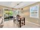 Cozy dining area adjacent to the kitchen, featuring a modern light fixture, a table with seating for four, and natural light at 11423 Brighton Knoll Loop, Riverview, FL 33579